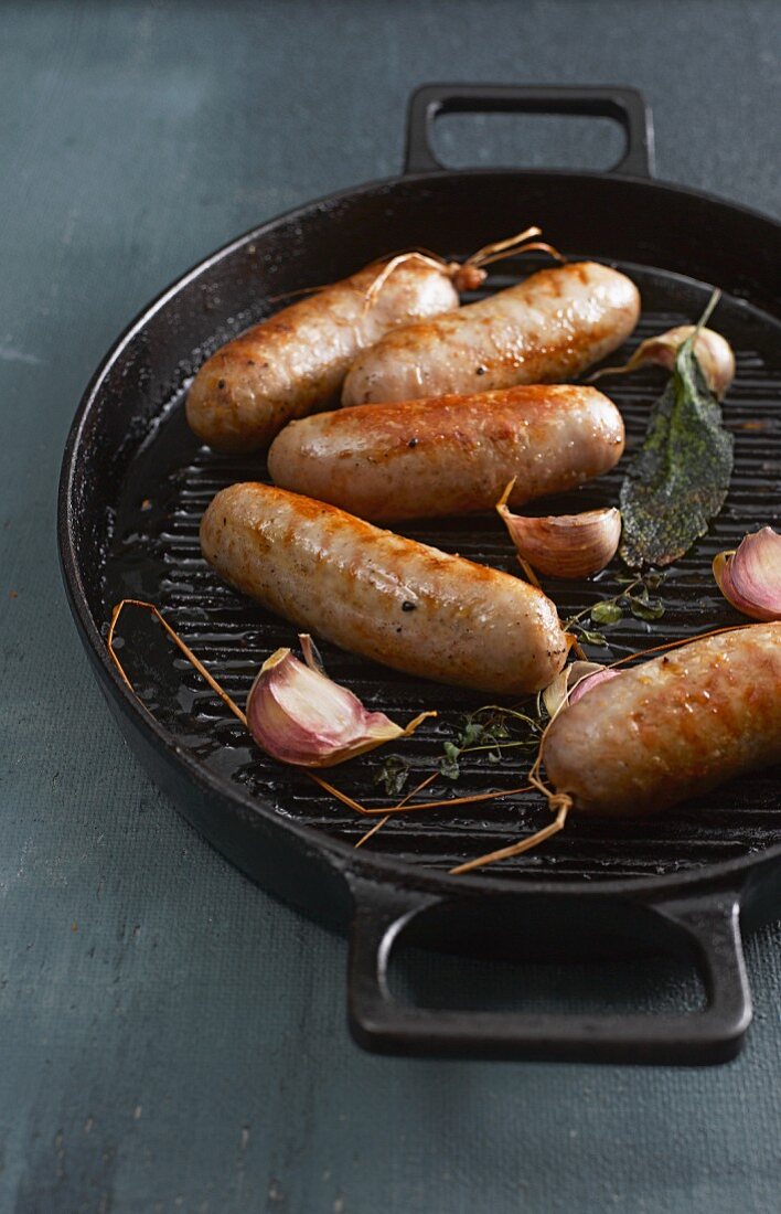 Sausages with garlic and sage in a pan