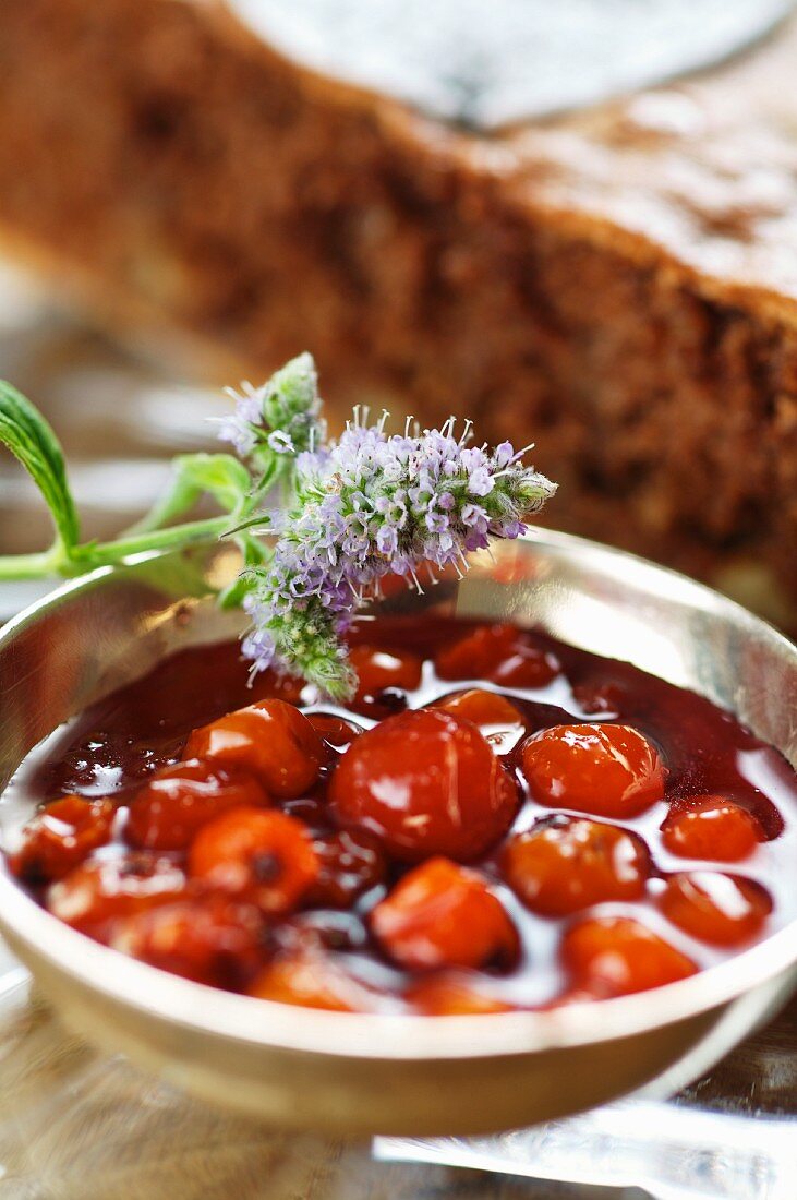 Rowanberry compote in front of a walnut torte
