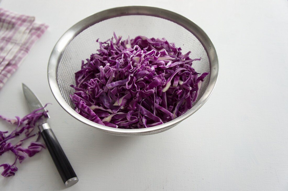 Chopped red cabbage in a sieve