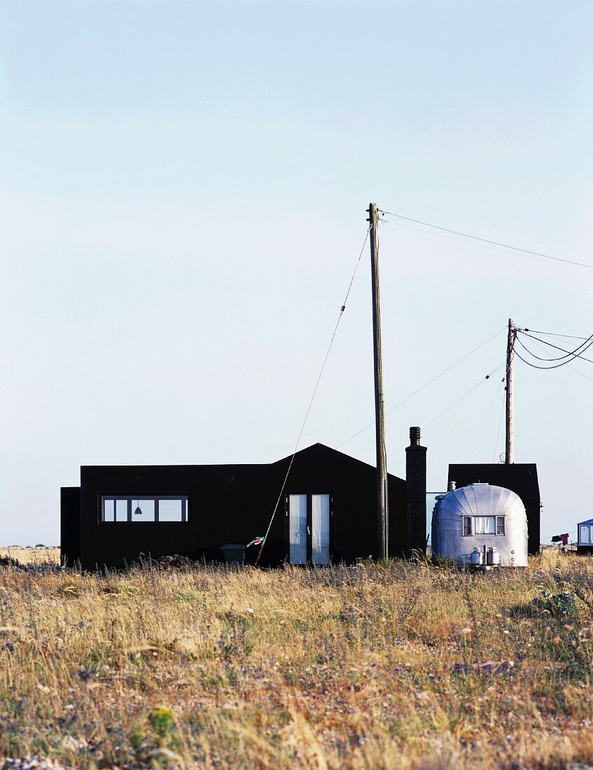 House with black facade and metal, retro caravan