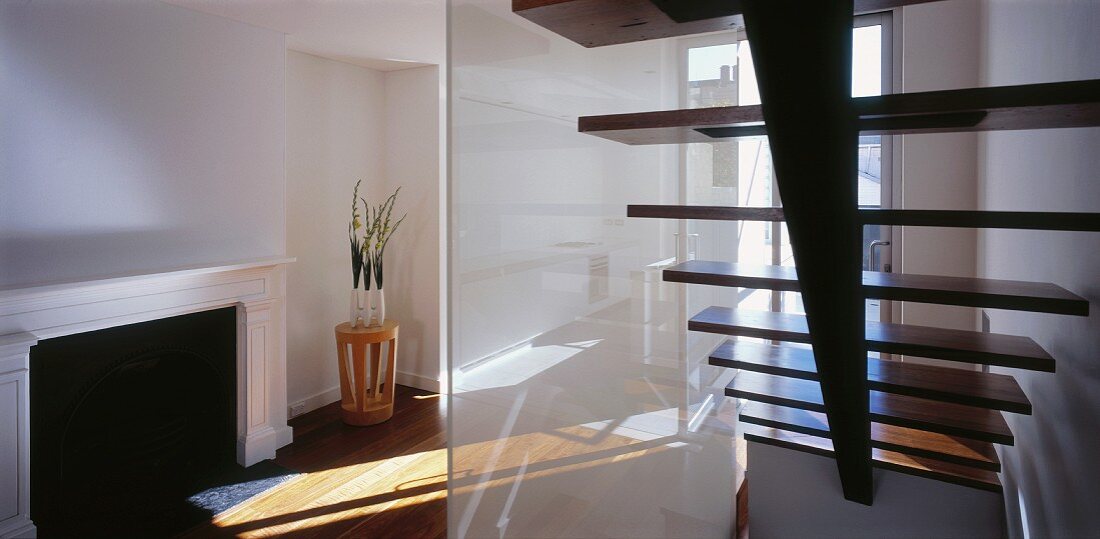 Staircase with glass partition in living space