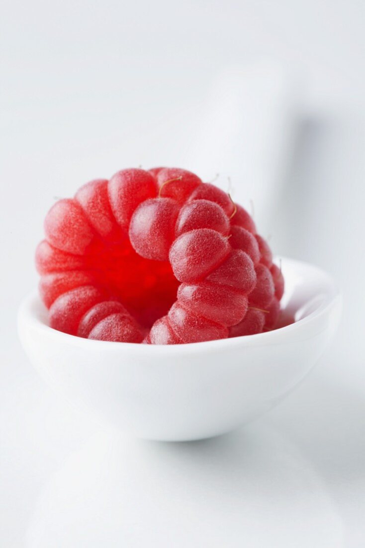 A raspberry on a spoon (close-up)