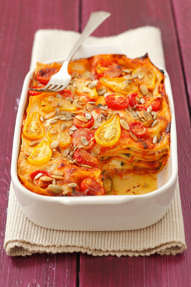 Courgette and tomato lasagne with sunflower seeds