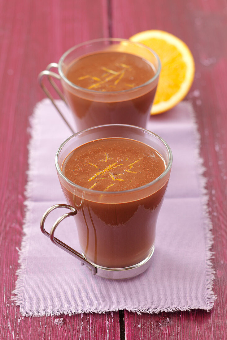 Hot chocolate in glass cups with orange zest