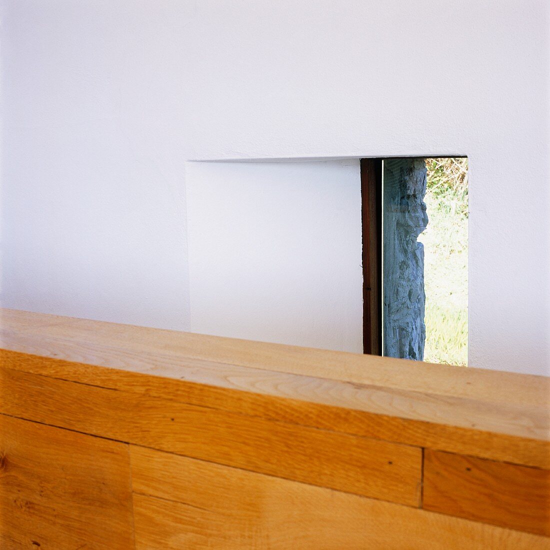 Detail of half-height wooden wall in front of window