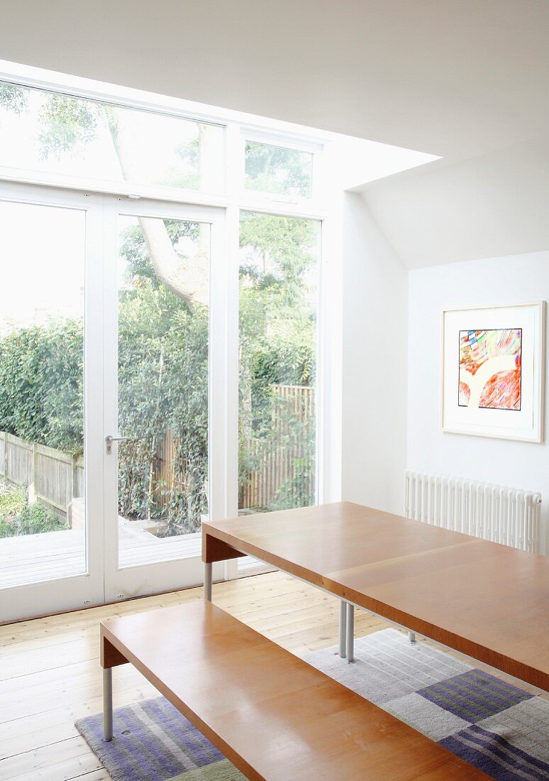 Dining table and bench in front of terrace door