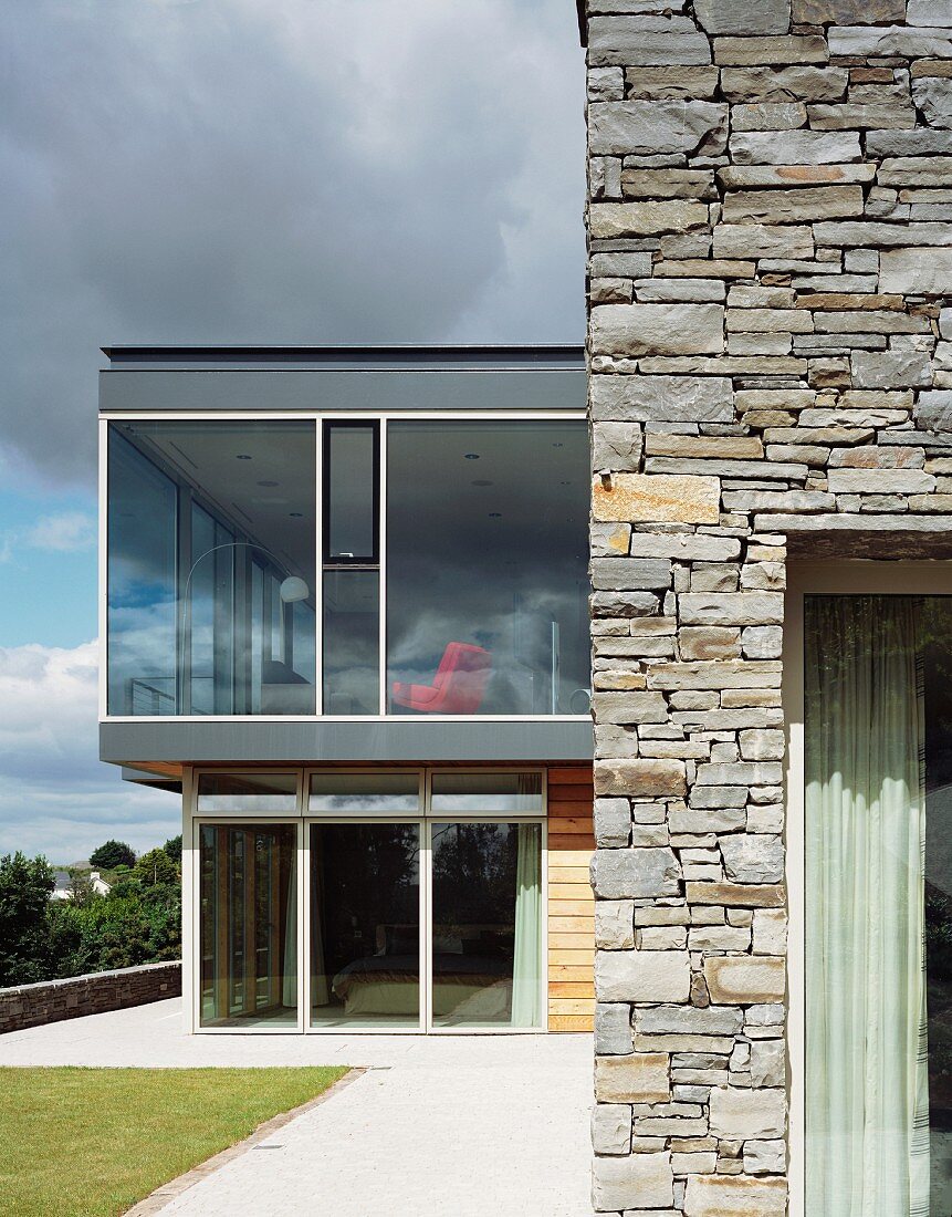 House with stone wall and glass extension