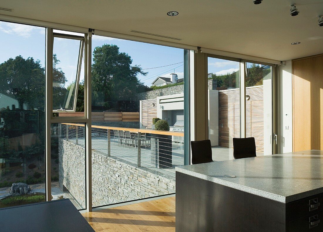 Kitchen with island and glass wall