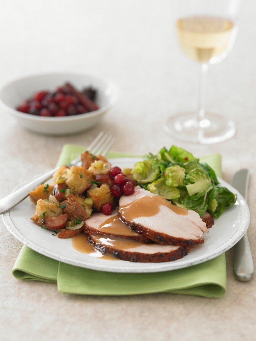 Plate of Sliced Turkey with Gravy, Stuffing and Brussels Sprouts