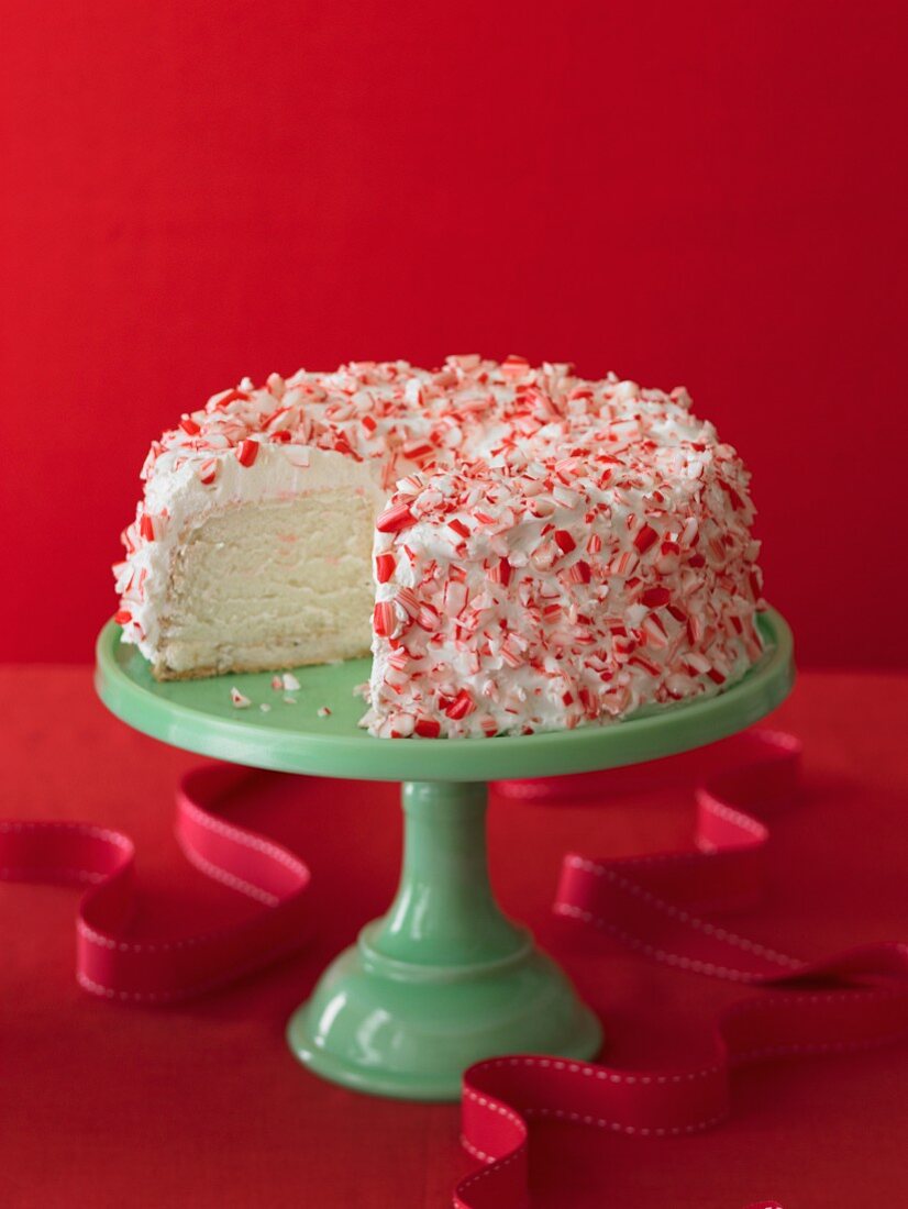 Peppermint Cake on a Green Cake Stand with a Slice Removed