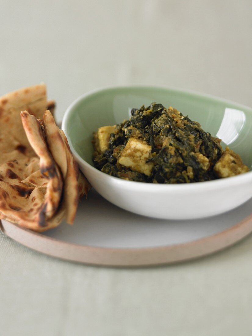 Bowl of Saag Paneer (Paneer Cheese with Spinach) with Flat Bread