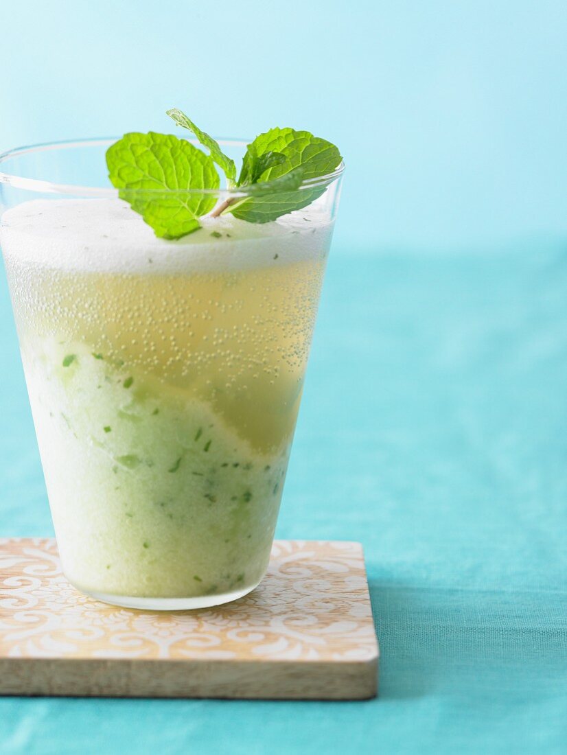 Honeydew Drink with Mint Garnish in a Glass