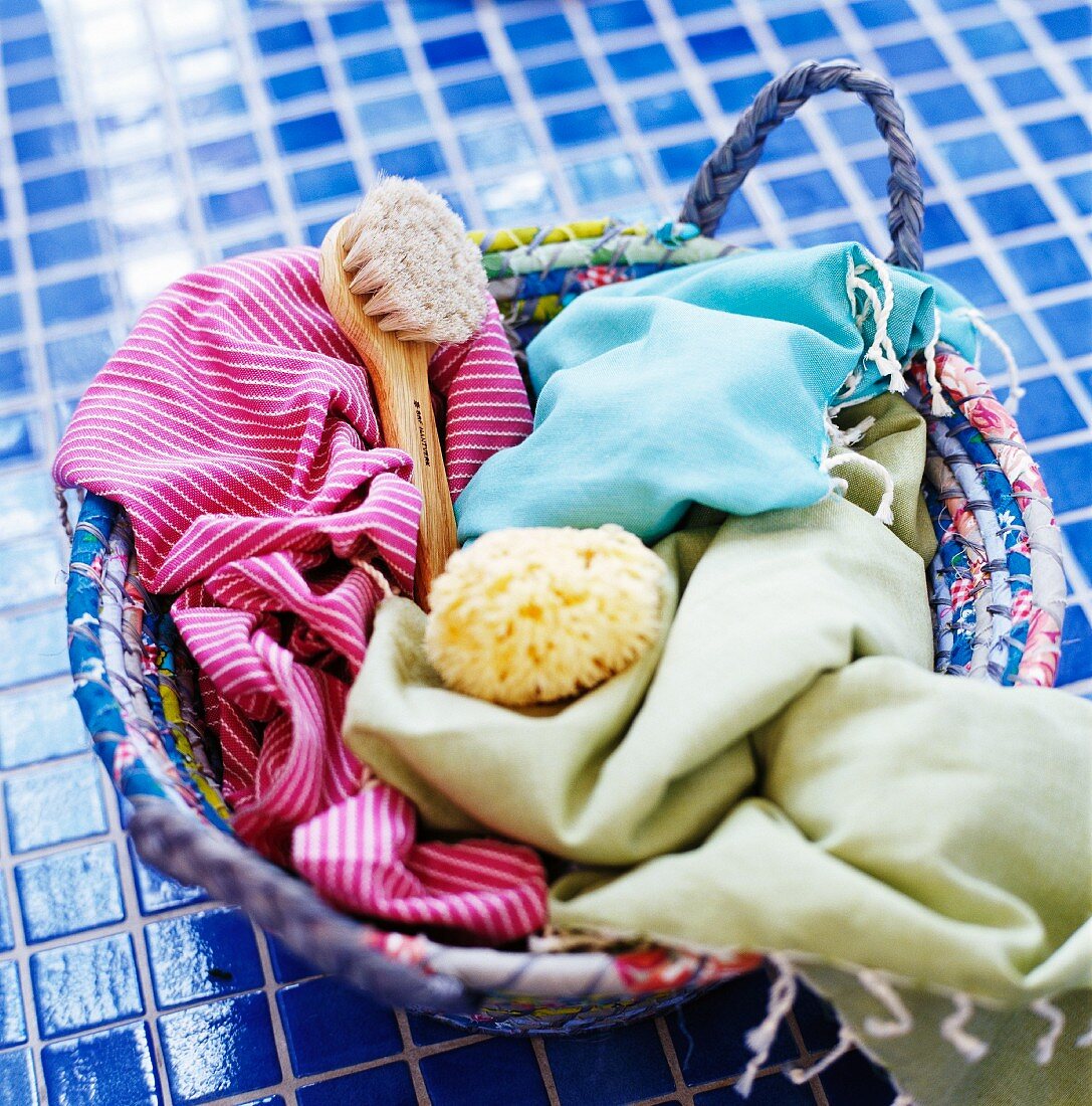 Bathing utensils in a basket on blue tiles