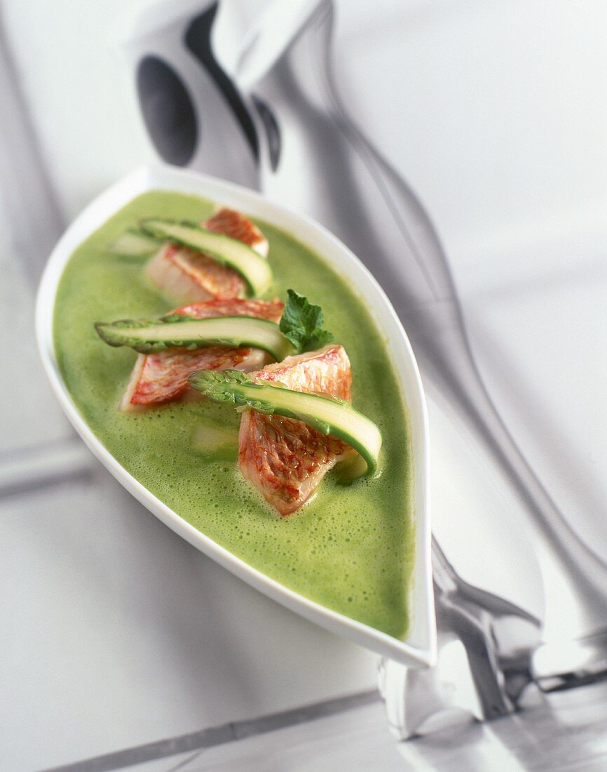 Cream of pea and asparagus soup with red mullet