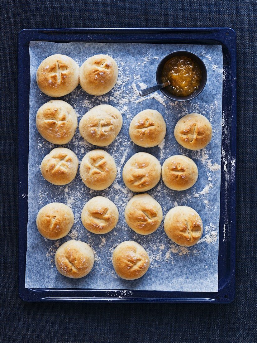 Scones with jam on a baking tray