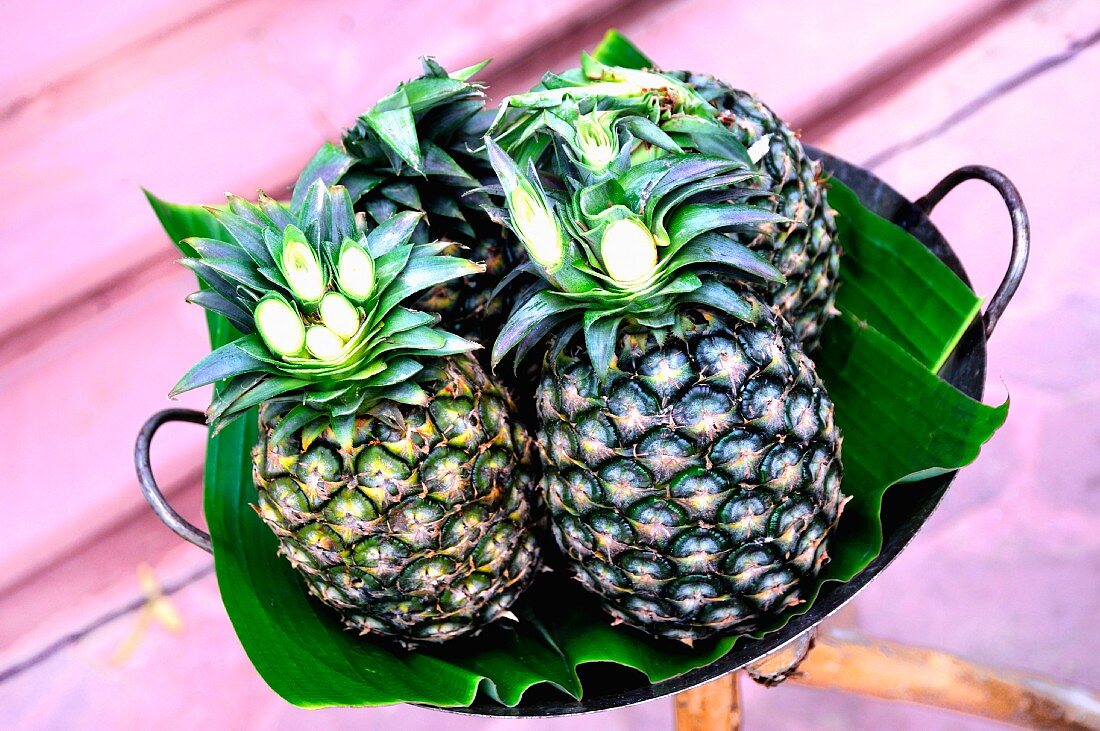 Fresh pineapple on banana leaves in a bowl