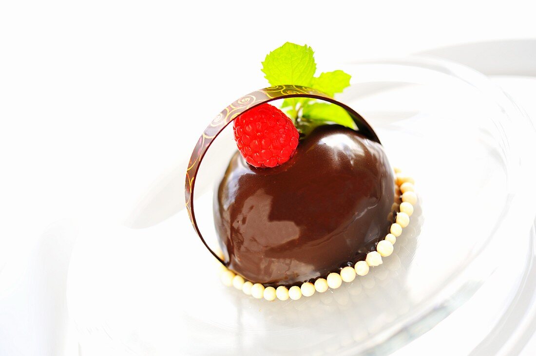 Passion fruit dessert with chocolate and raspberries