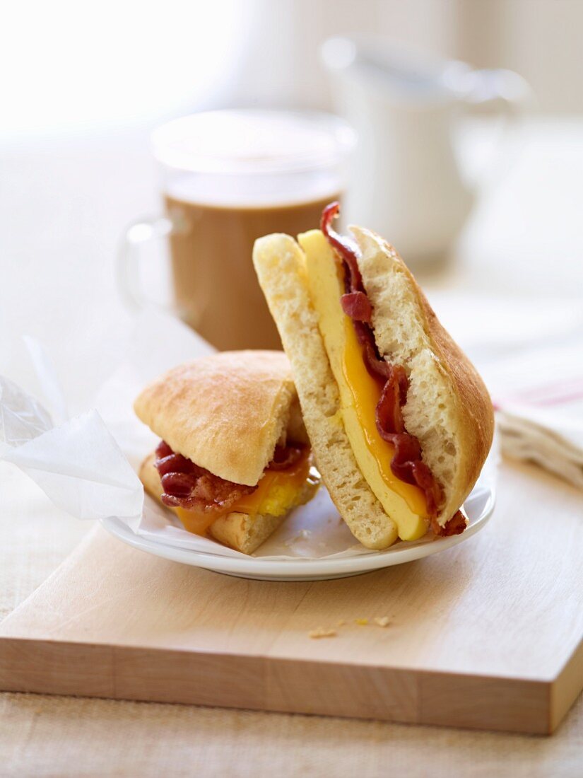 Bacon and Egg Breakfast Sandwich; Halved; Coffee