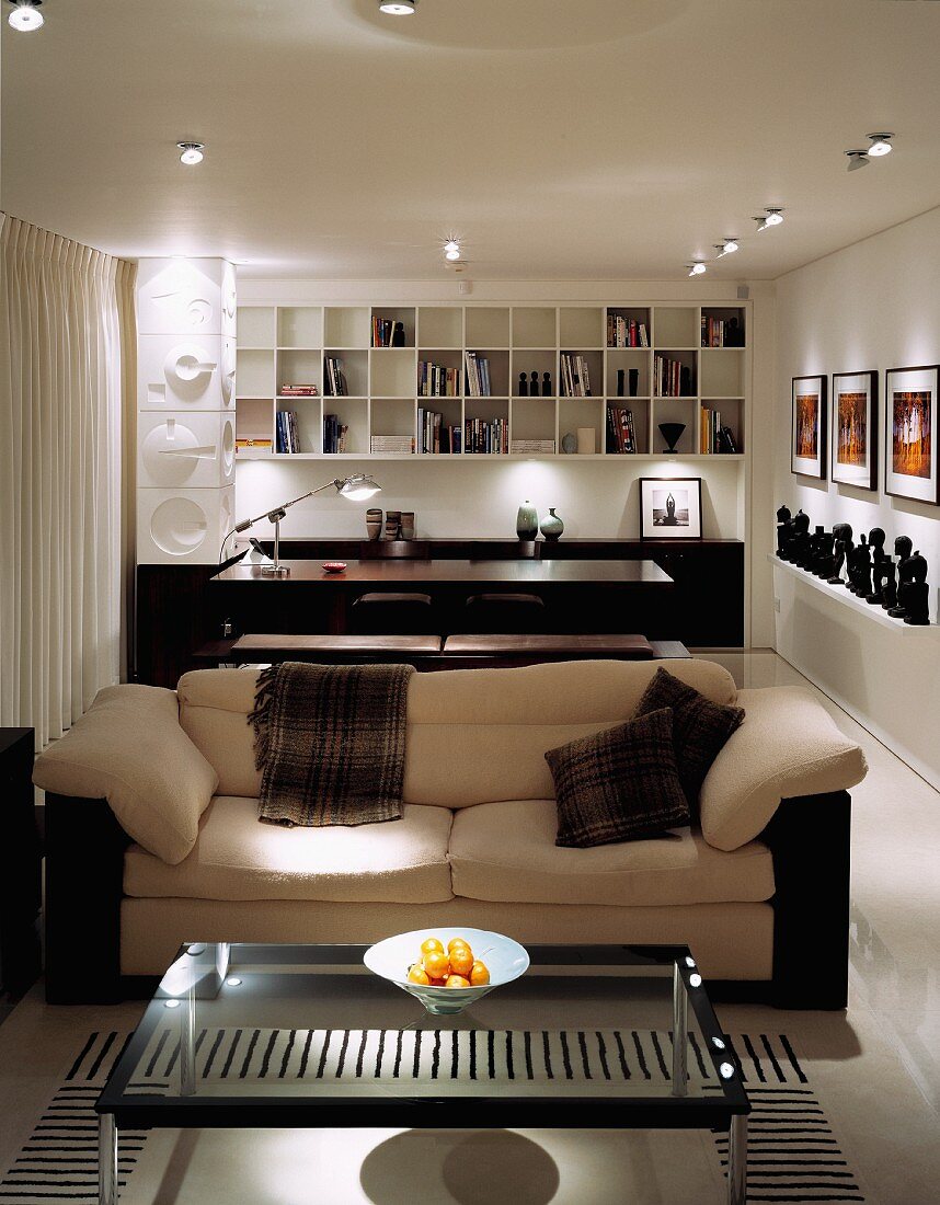 Long, open-plan living-dining room with contemporary brown and white furniture