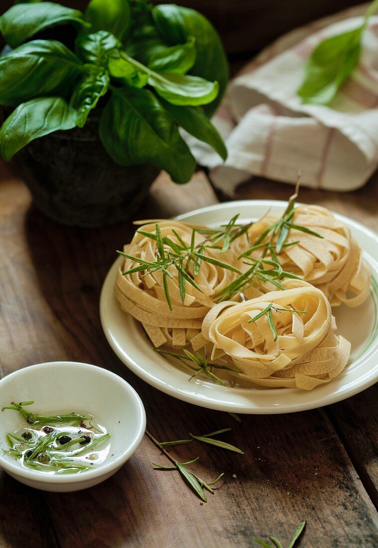 Uncooked tagliatelle with rosemary sprigs