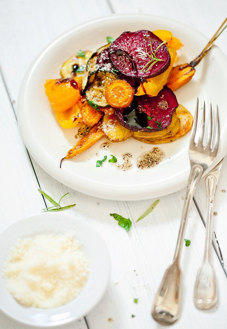 Warm salad made of roasted vegetables with parmesan