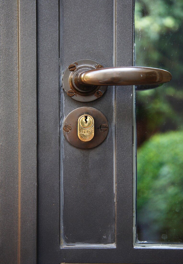 Historic glass door with metal frame, handle and lock