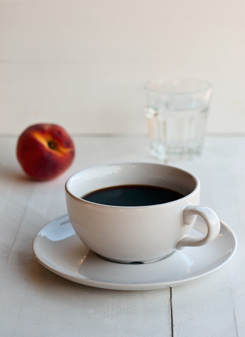 Coffee cup and a peach