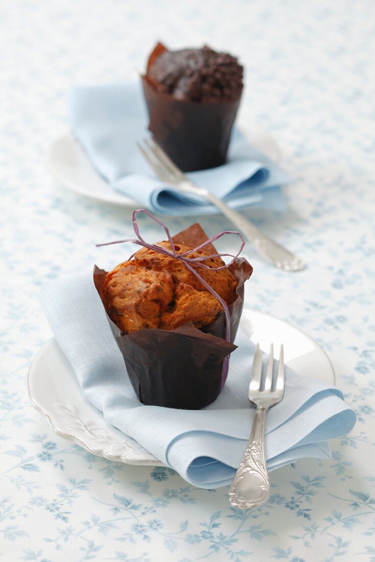 An apple muffin and a chocolate muffin