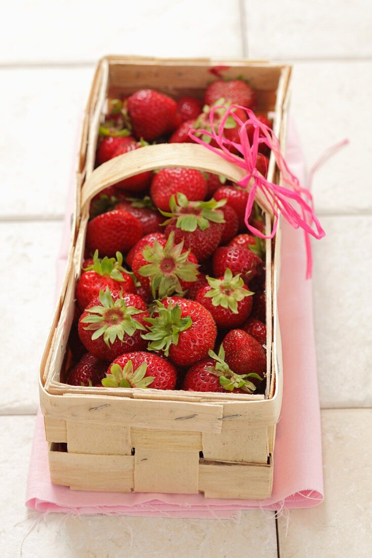 Fresh strawberries in a woodchip basket