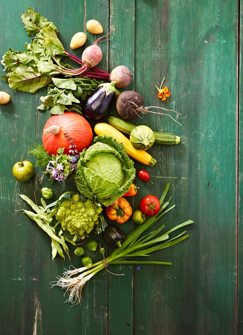 Various vegetables on a green wooden surface
