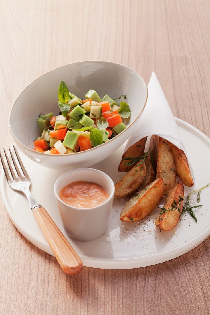 Vegetable salad, roasted potato wedges and cocktail dip