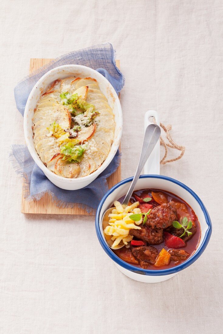 Potato casserole with savoy cabbage and ground beef and beef goulash with spätzle