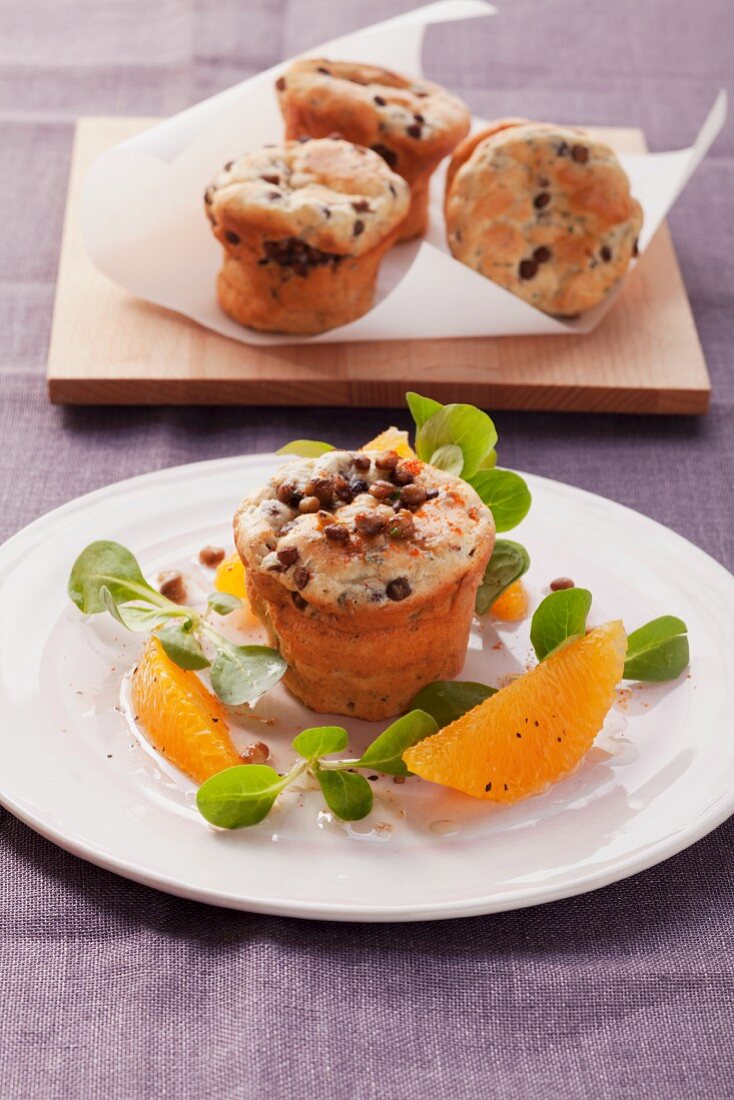 Lentil muffins garnished with oranges and lamb's lettuce salad