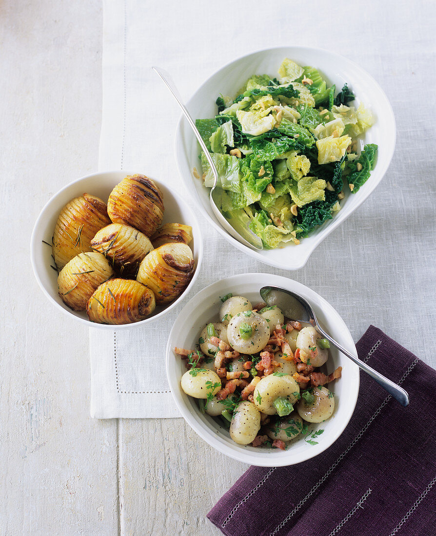 A savoy cabbage medley with nuts, white turnips with diced bacon and fanned potatoes