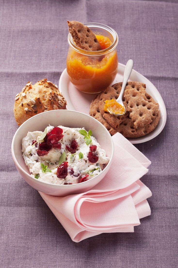 Cream cheese with cranberries and basil and apricot preserves with crisp bread