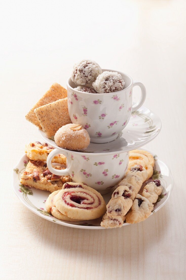 Assorted cookies on a cake stand made of coffee cups