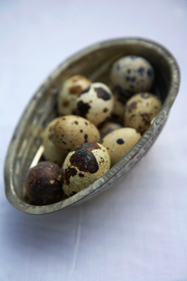 Quail eggs in a egg-shaped bowl