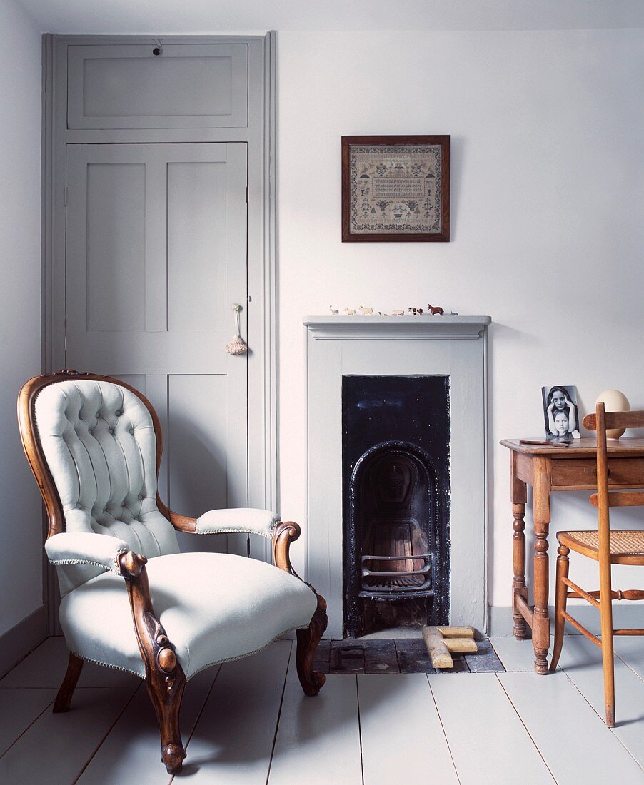 Antique armchair next to open fireplace