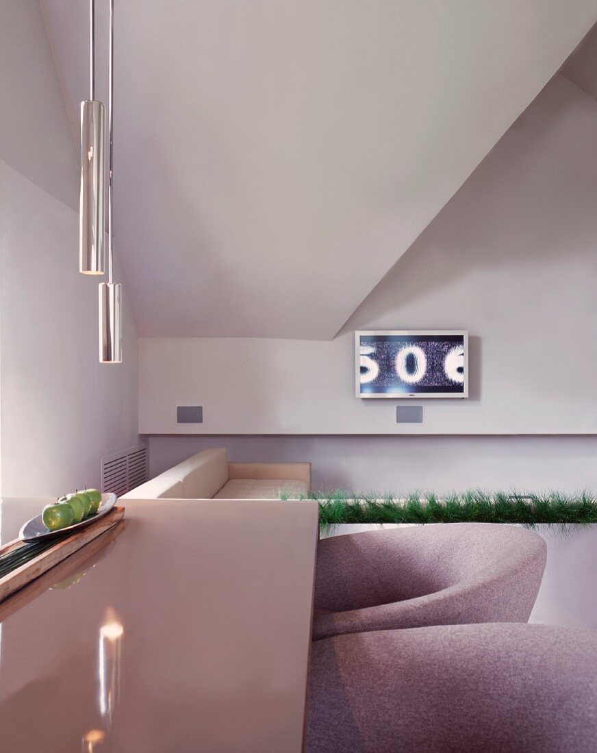 Corner of living room with upholstered club armchairs at dining table with reflective surface