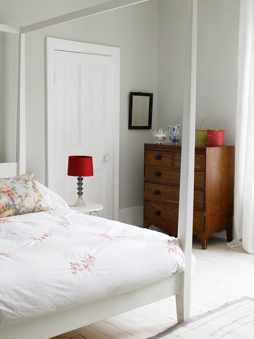 Bedroom with canopied bed & old chest of drawers