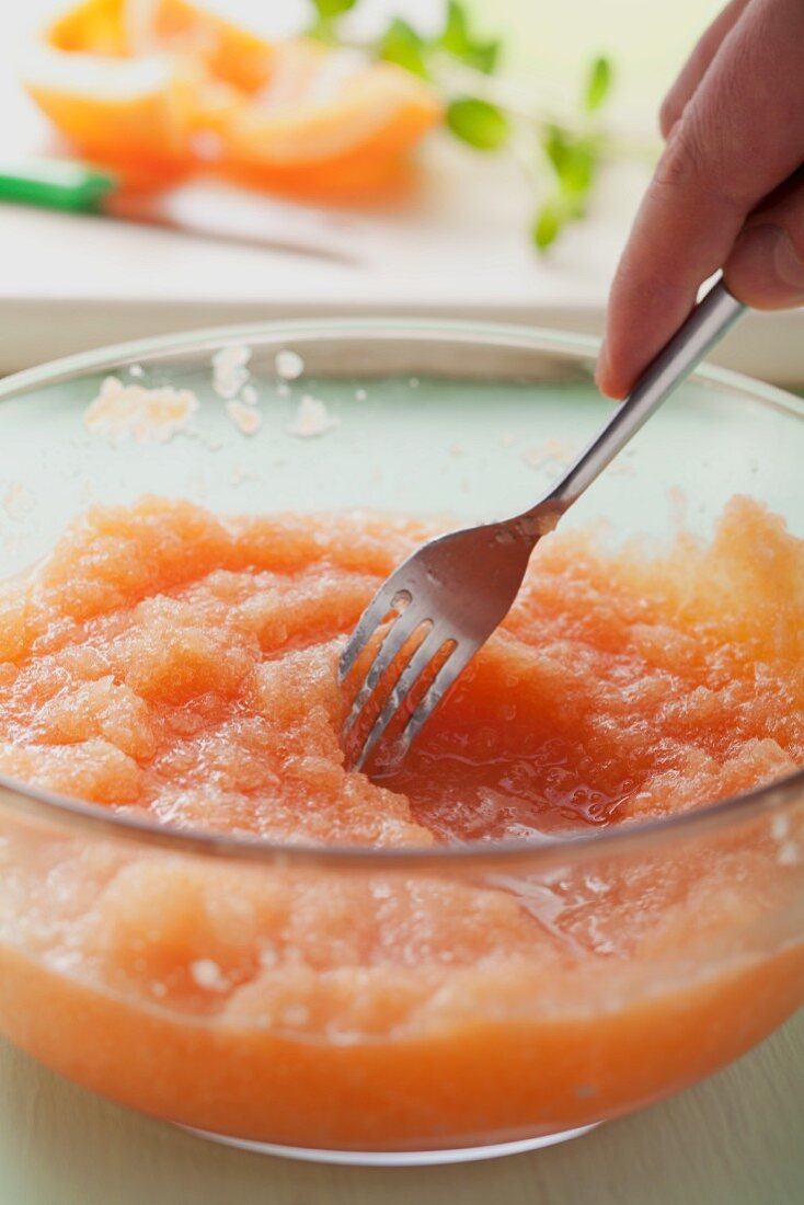 Whisking melon sorbet with a fork