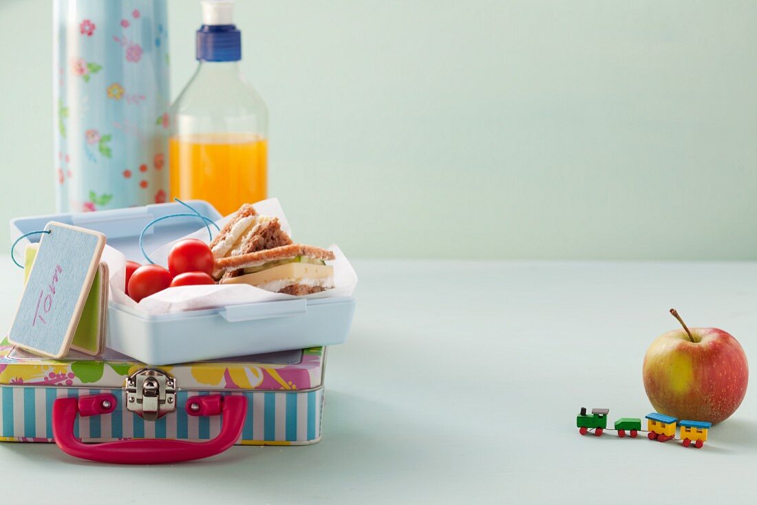 Wholemeal sandwiches and tomatoes in a lunchbox