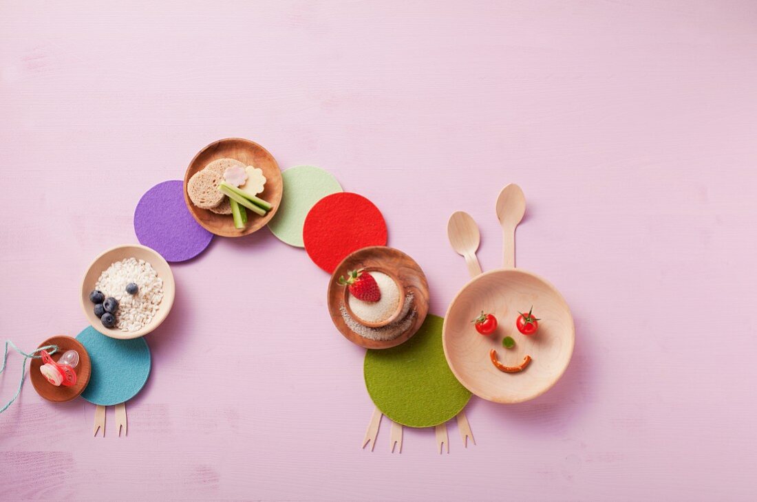Plates with healthy ingredients arranged in a caterpillar