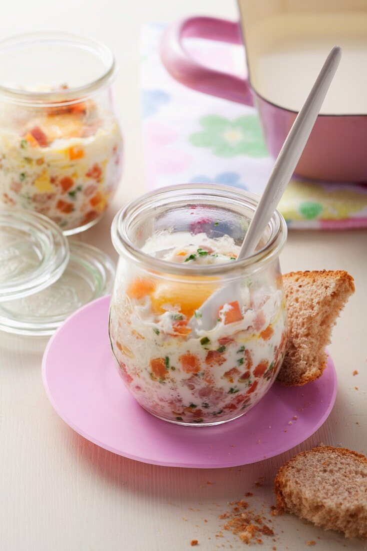 Chopped vegetables and egg in glass jar