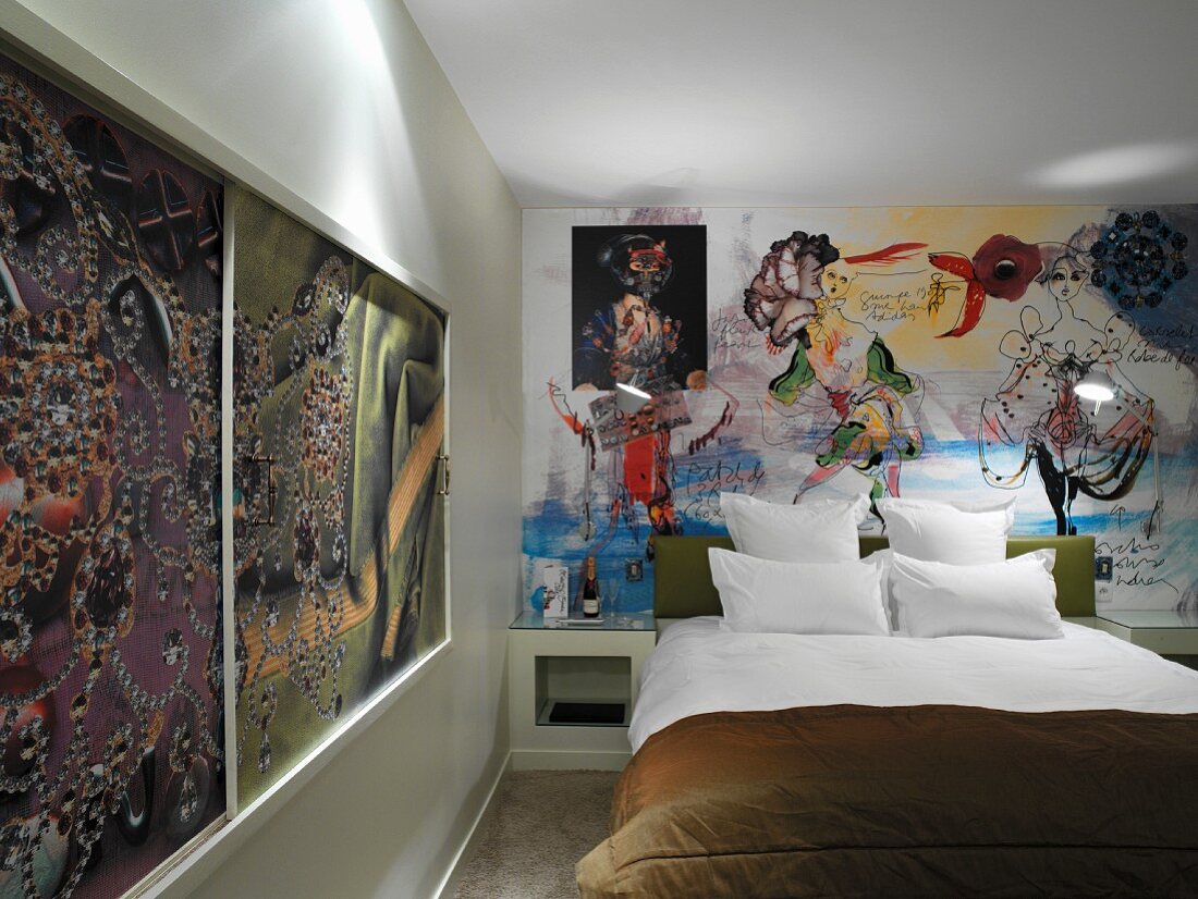 Printed sliding panels in wooden frame and mural behind double bed in retro hotel room