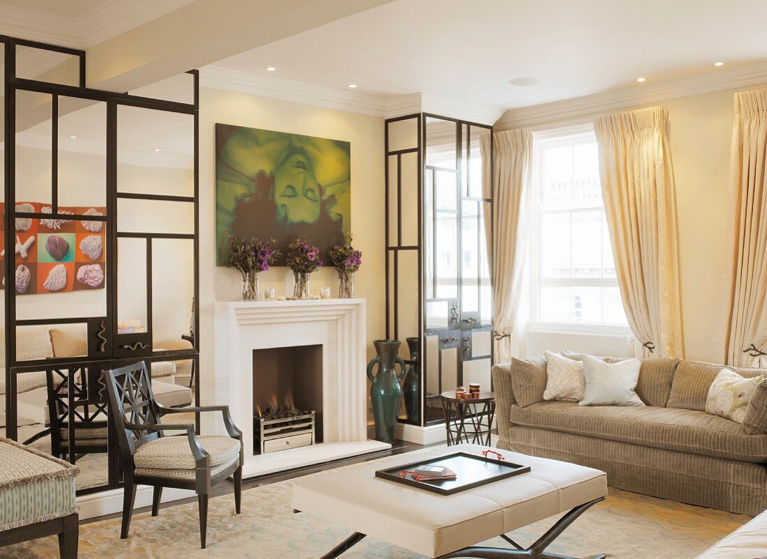 Elegant living room with mirrored elements on both sides of fireplace