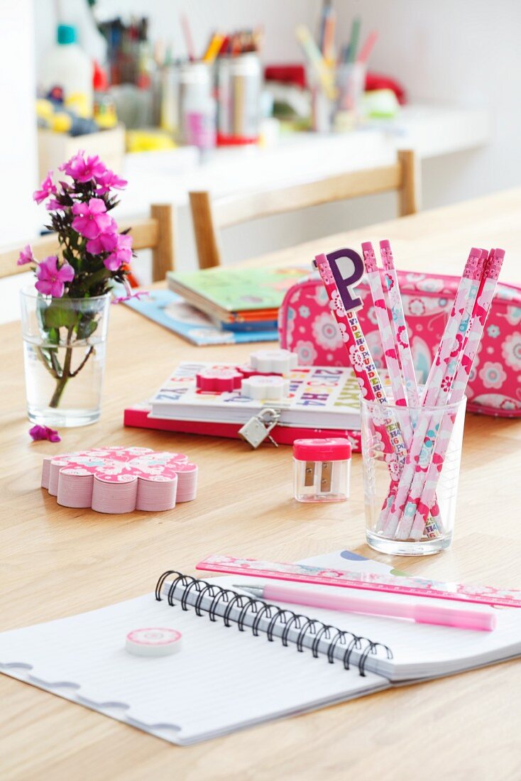 Various pink writing materials on table