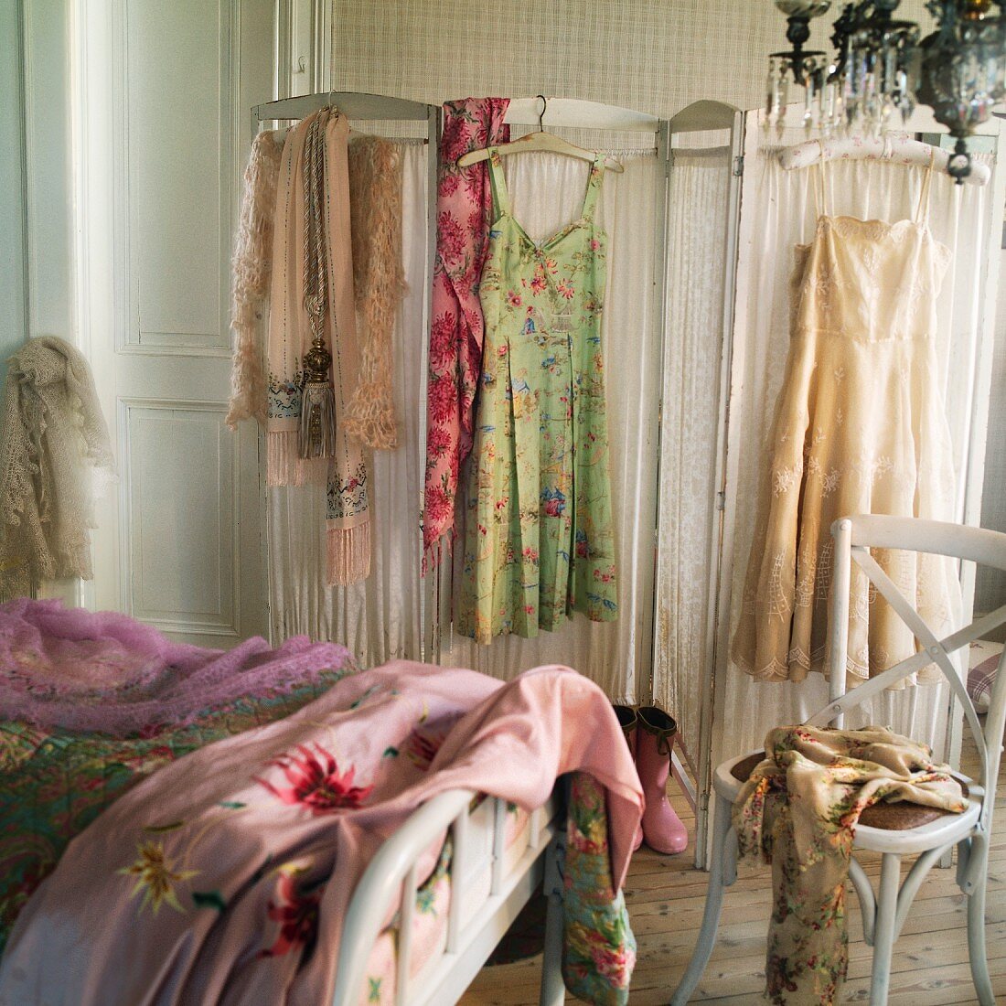Boudoir with vintage ladies clothing hanging on a screen