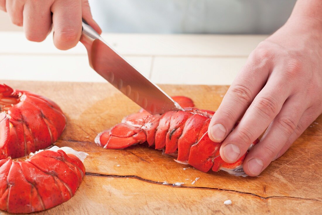 Cutting open a lobster tail lengthways