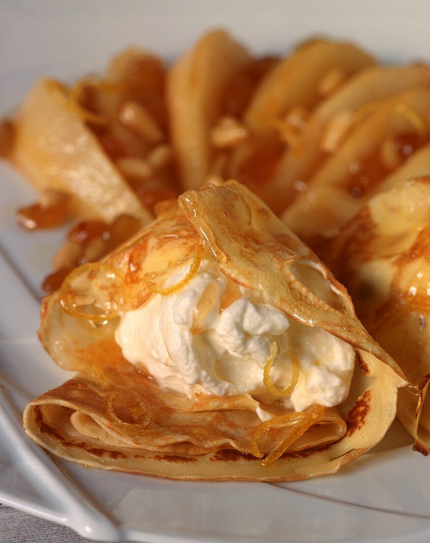 Crepes with cream-cream cheese filling, orange caramel and pine nuts